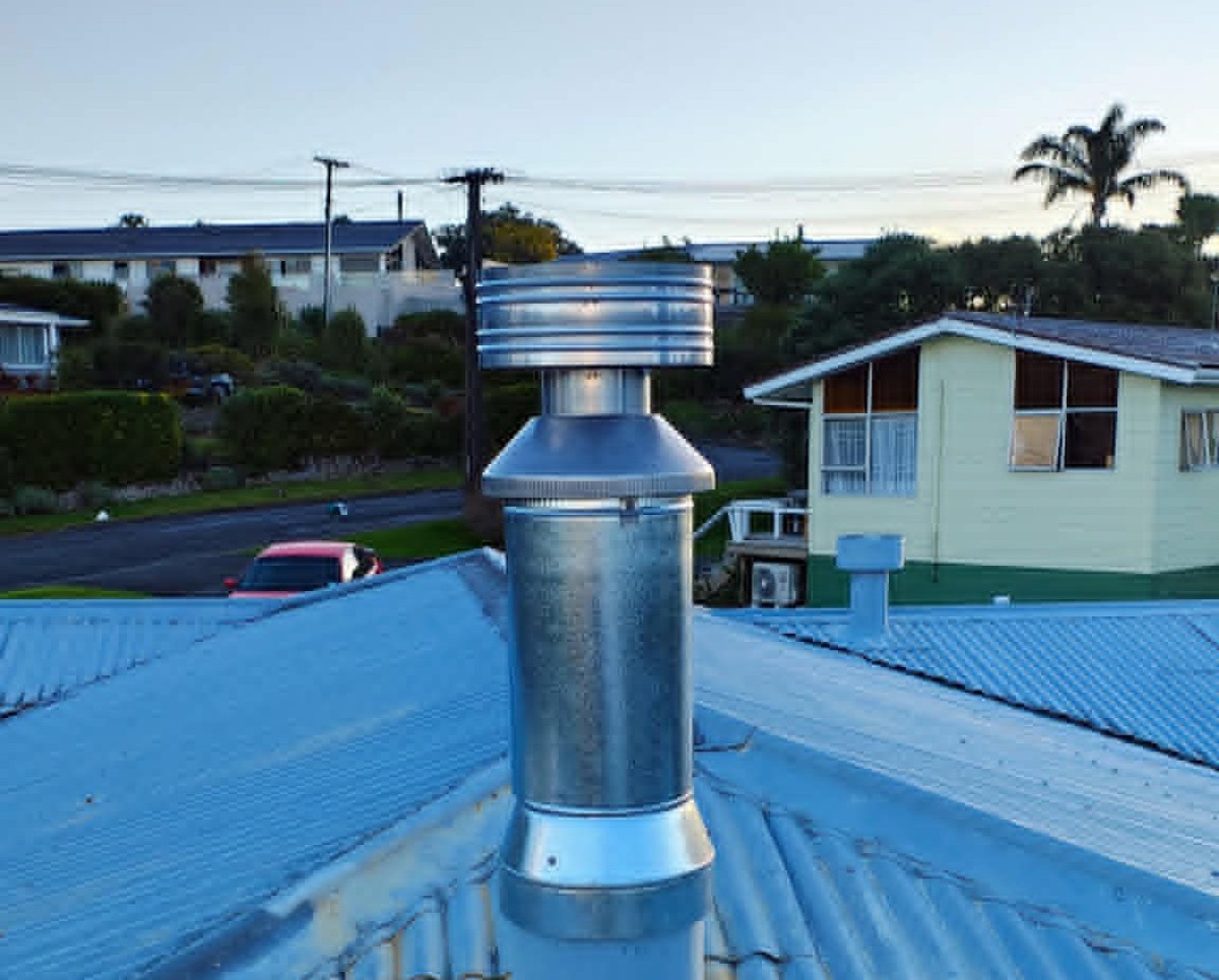 A new galvanised stainless flue and cowl on the same roof — after the Premium Fires re-flue