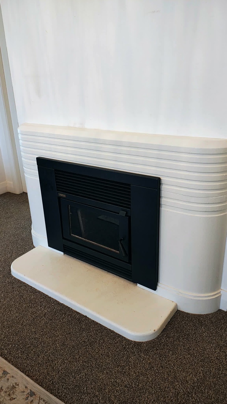 A modern inbuilt wood fire installed by Premium Fires